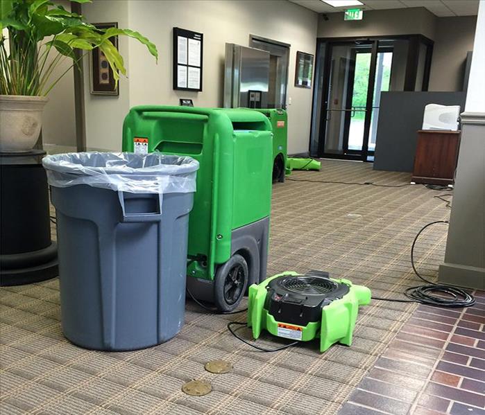LGR, air mover, and gray trash container by the vault, brown carpet