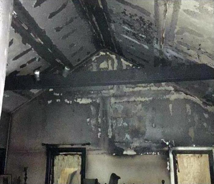 soot and fire damage in an A-frame interior