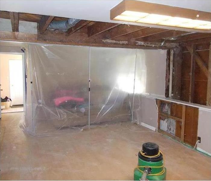 containment barrier of poly covering couch plus, some demolition on ceiling and walls