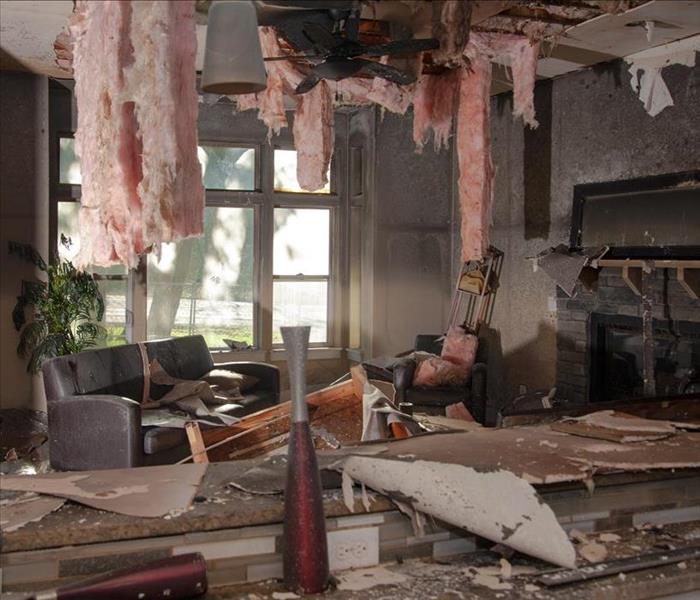 A living room and kitchen with fire damage.  